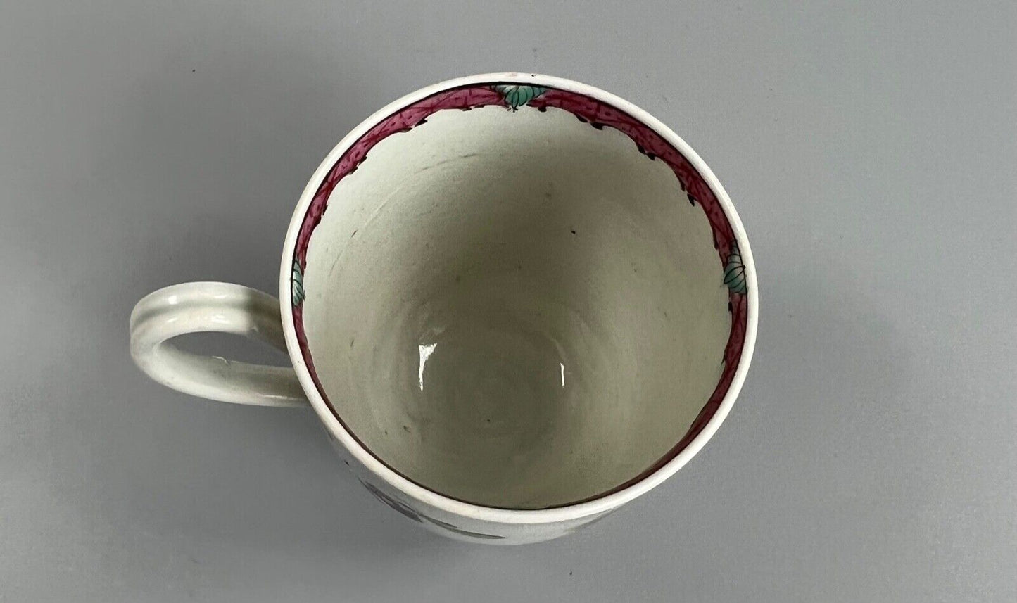 A Seth Pennington Liverpool coffee cup w/painted border & floral decoration