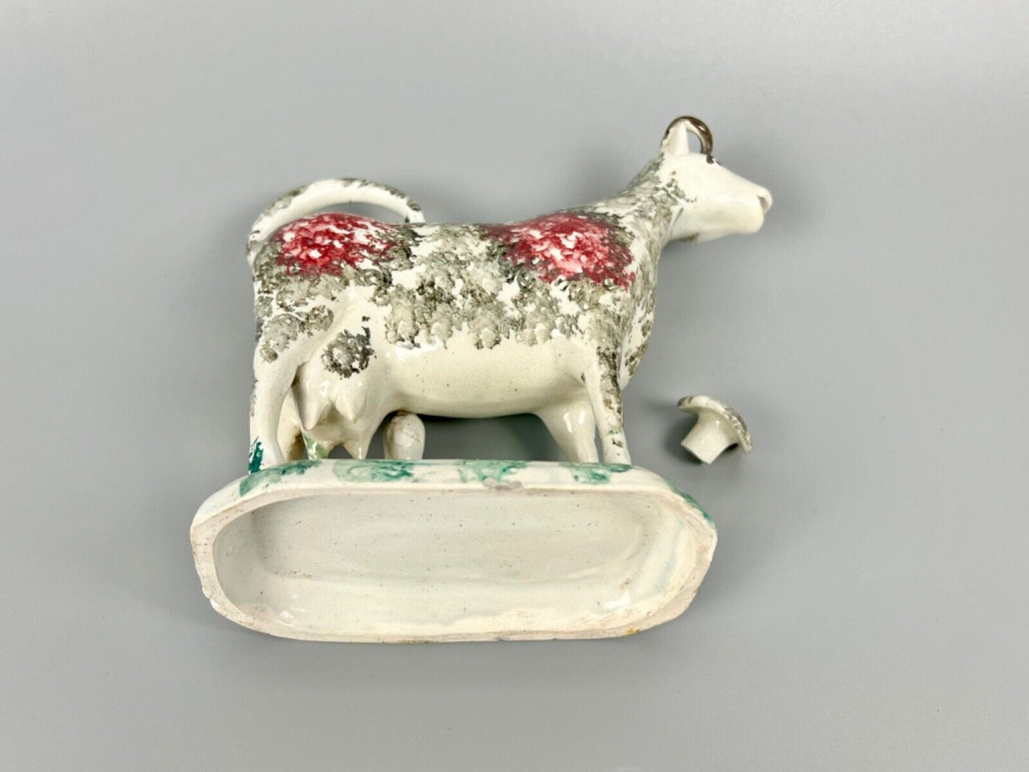 A c.1820 pottery cow and milkmaid creamer in crimson and black. Poss. Yorkshire