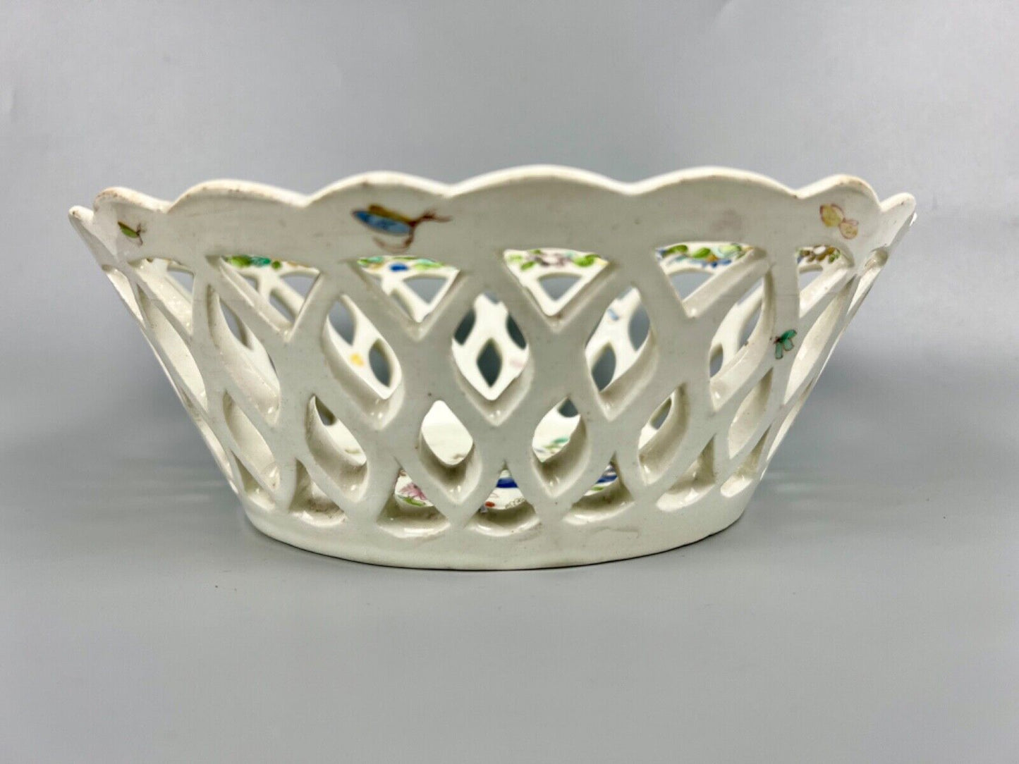 A pair of large Bow porcelain famille rose reticulated baskets c.1752