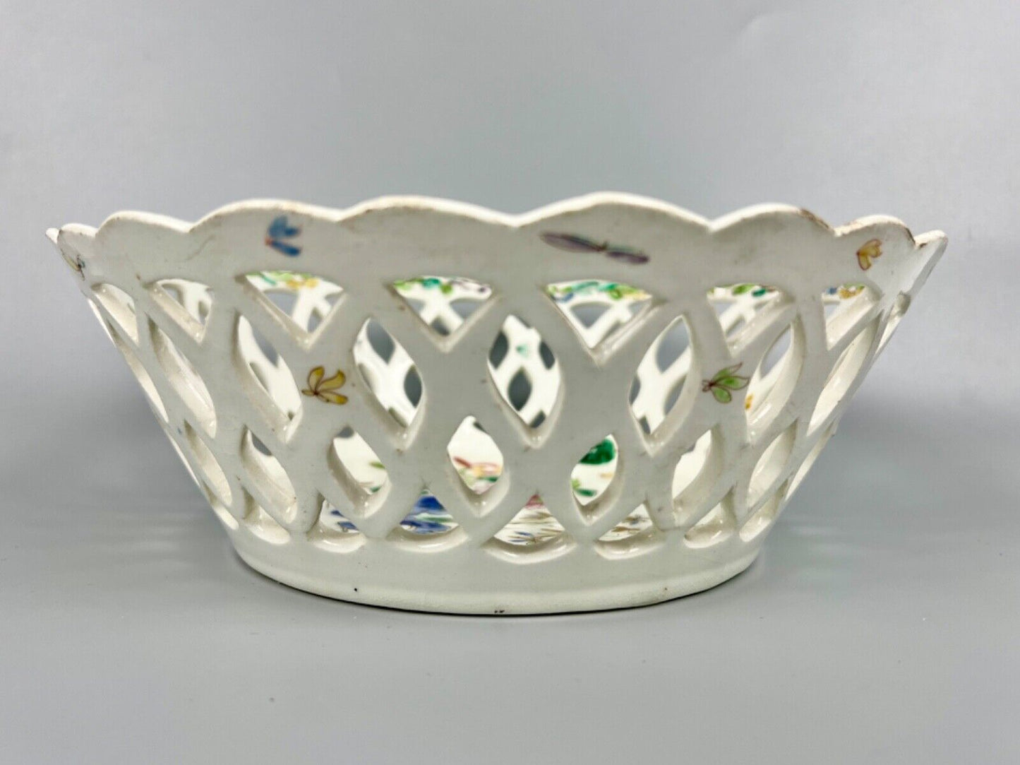 A pair of large Bow porcelain famille rose reticulated baskets c.1752