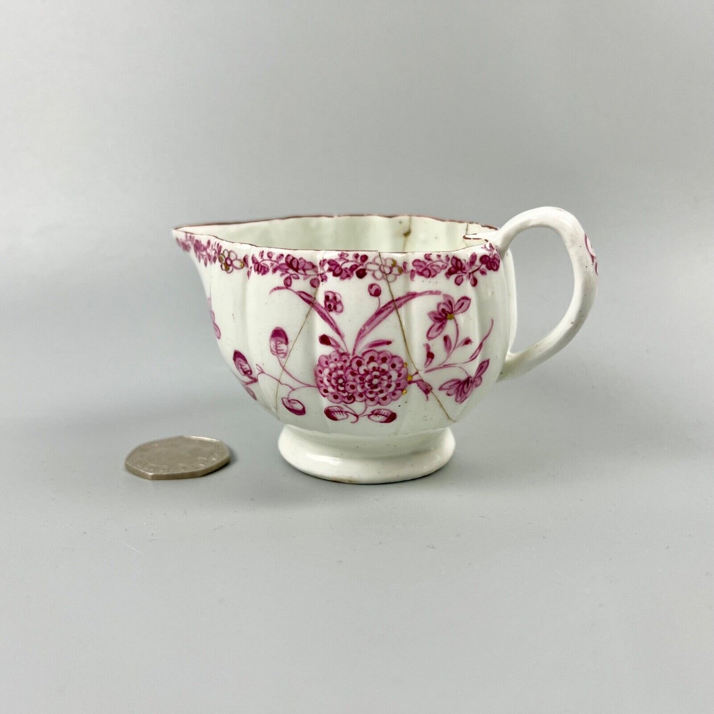 A rare early Derby peach-shaped creamer in 'Banded Hedge' pattern c.1765