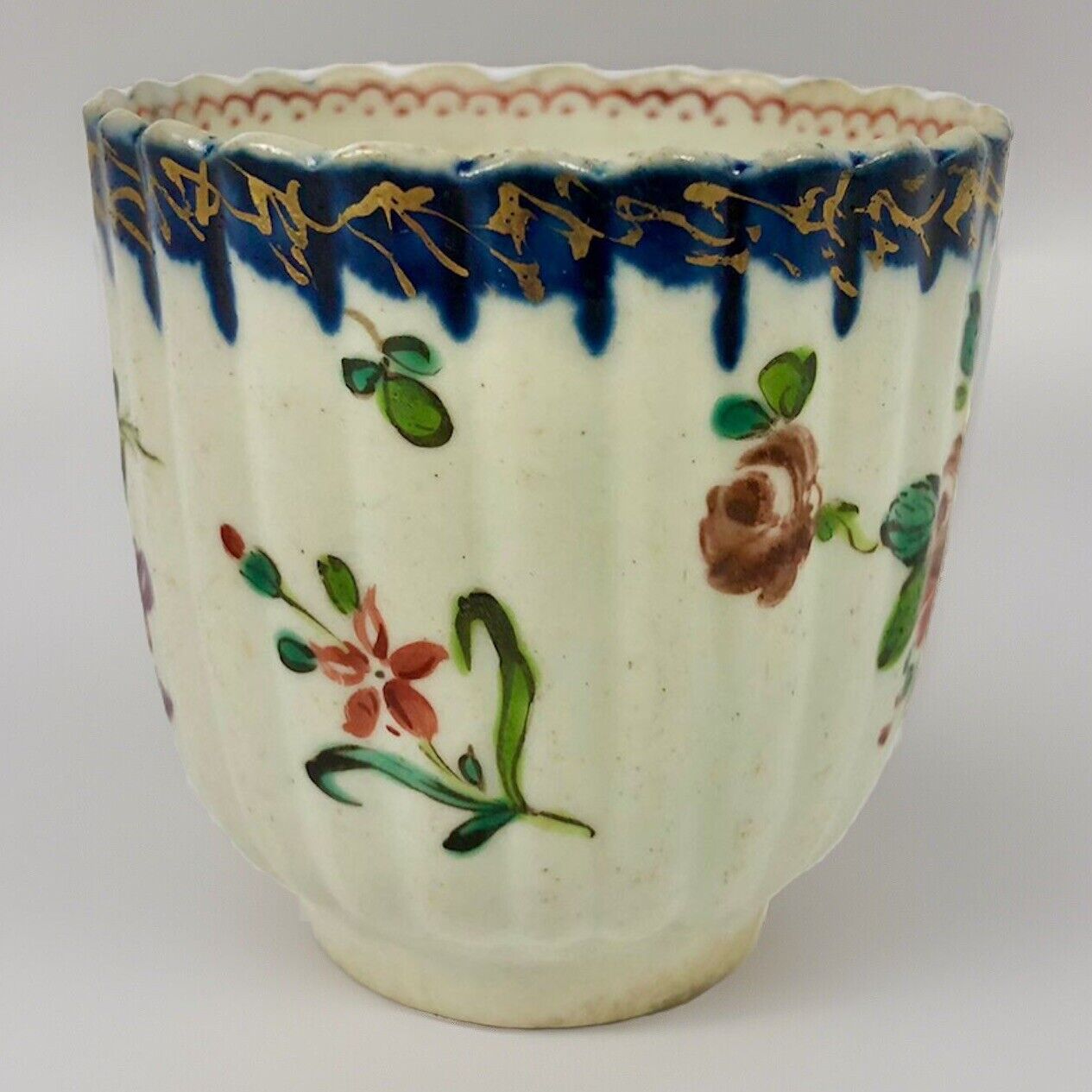 A Seth Pennington fluted coffee cup with blue and gilt border .1780-90