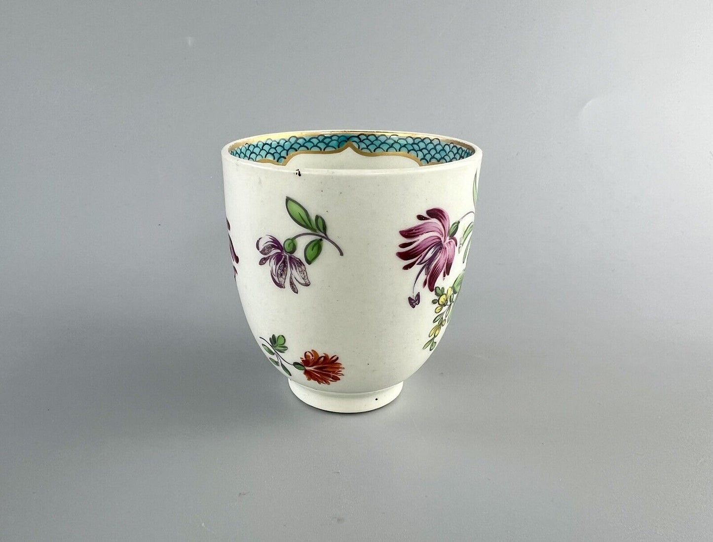 A 1st Period Worcester polychrome coffee cup c1770. Sprung handle.