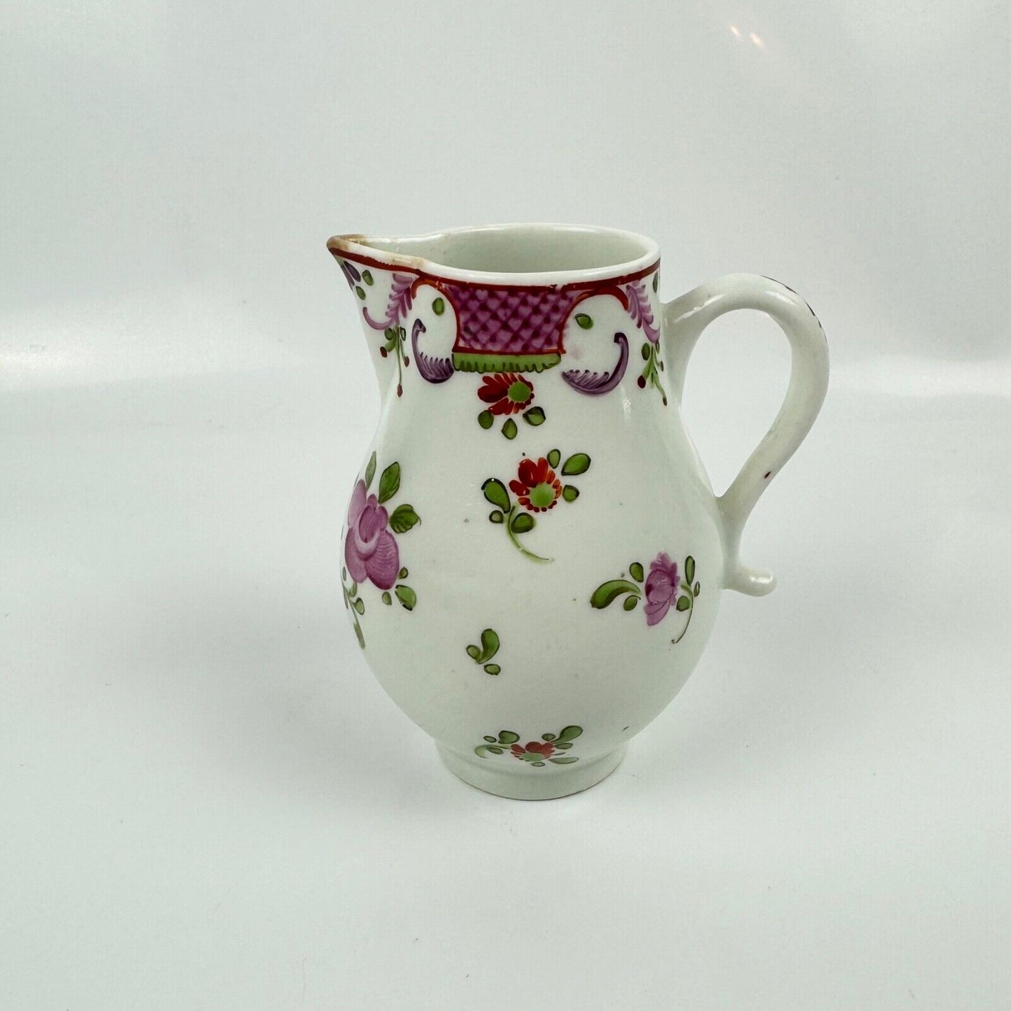 A Lowestoft sparrowbeak creamer c1775 painted with a Curtis style pattern
