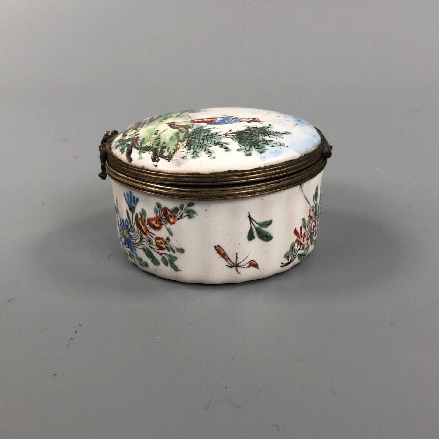 An early 19thc. Continental enamel box. Hand Painted with a boy piper.
