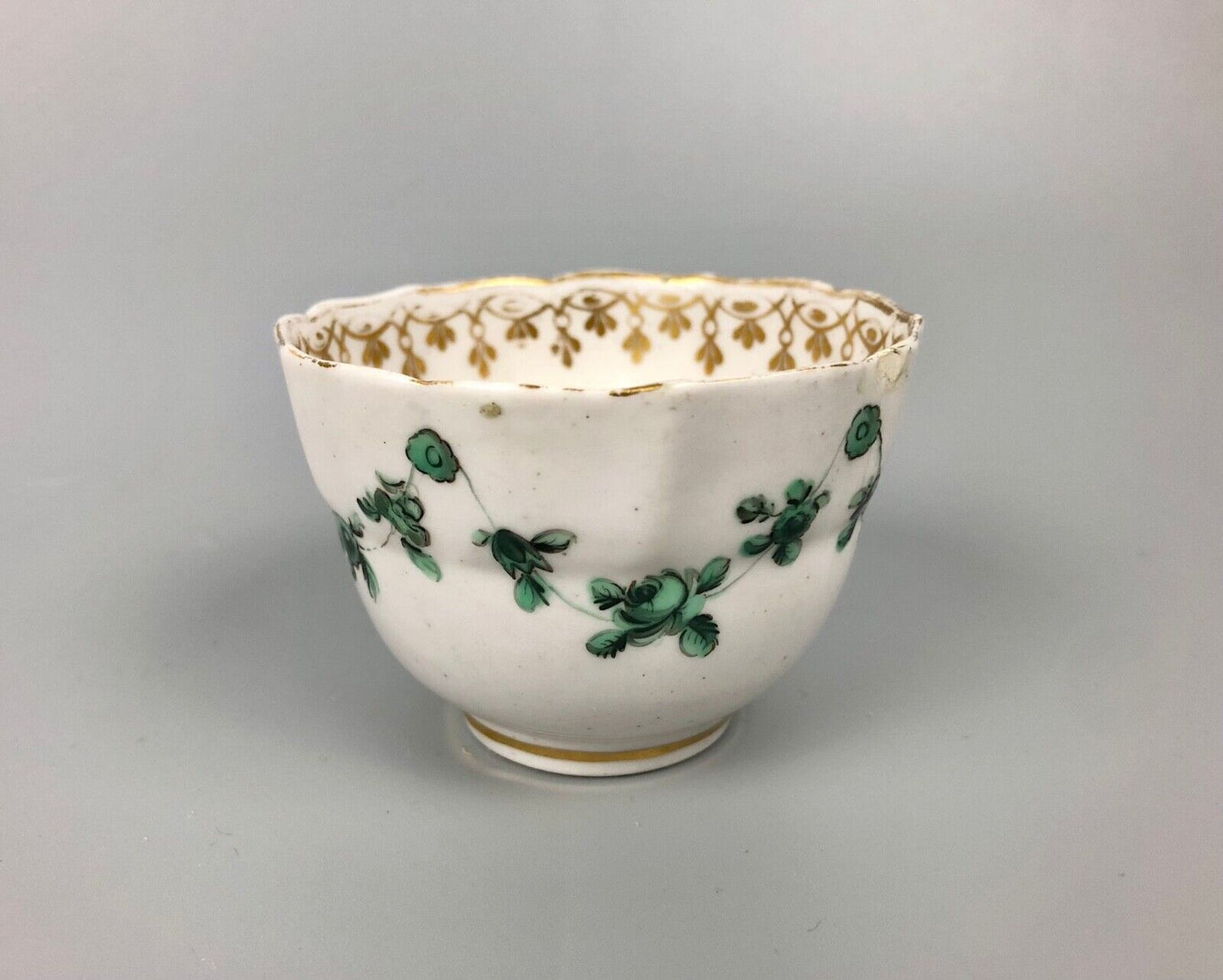 A Derby tea bowl and saucer in the style of Bristol c.1775