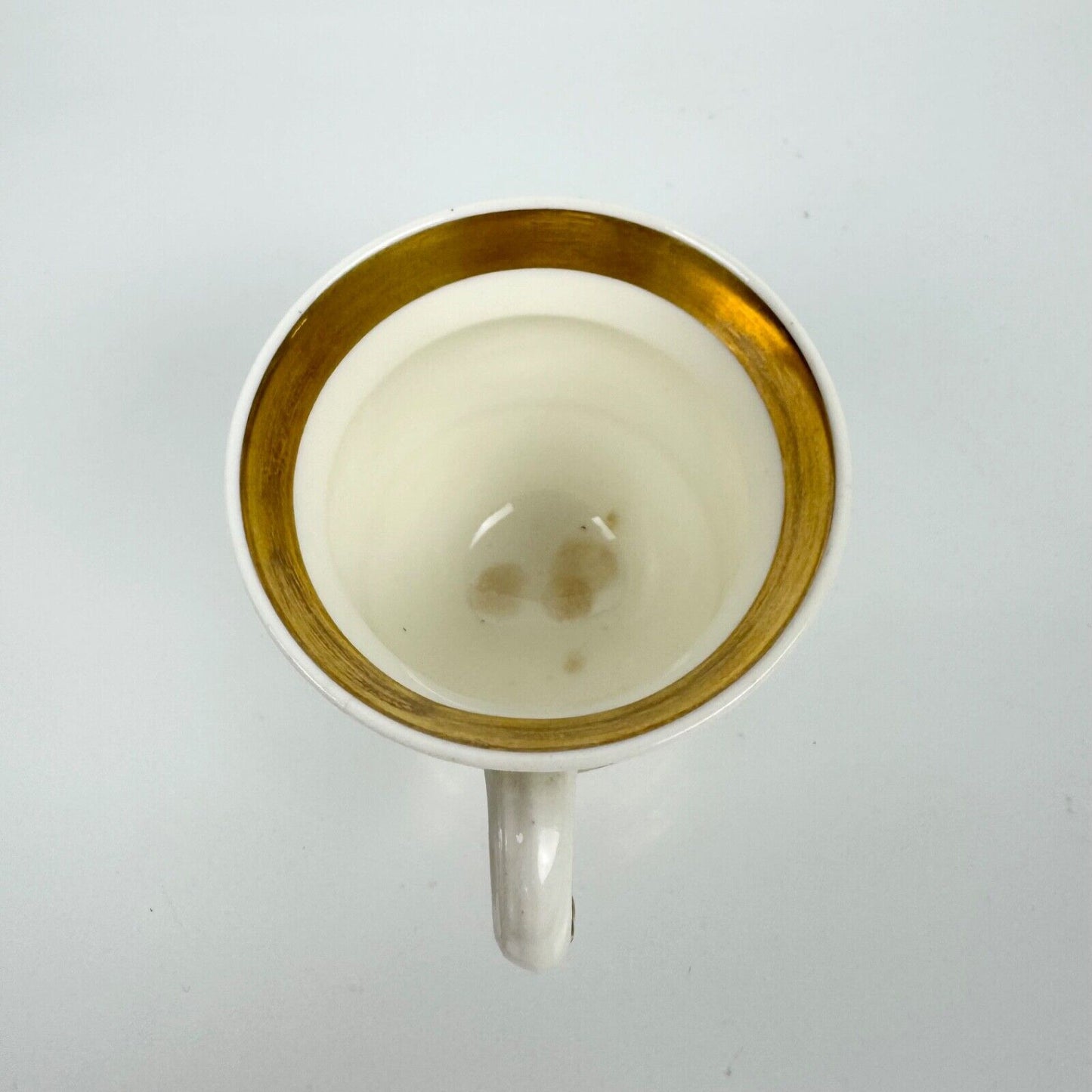 Rockingham horsetail & hoof handled coffee cup& saucer. Red griffin mark. c1826.