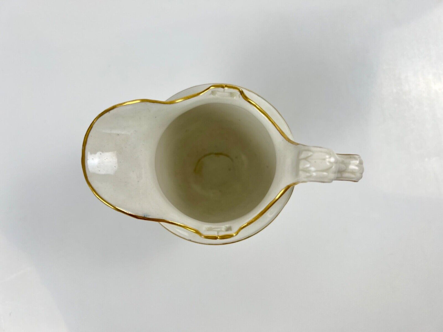 A Chelsea-Derby cabaret creamer of empire shape painted with mask heads c.1770