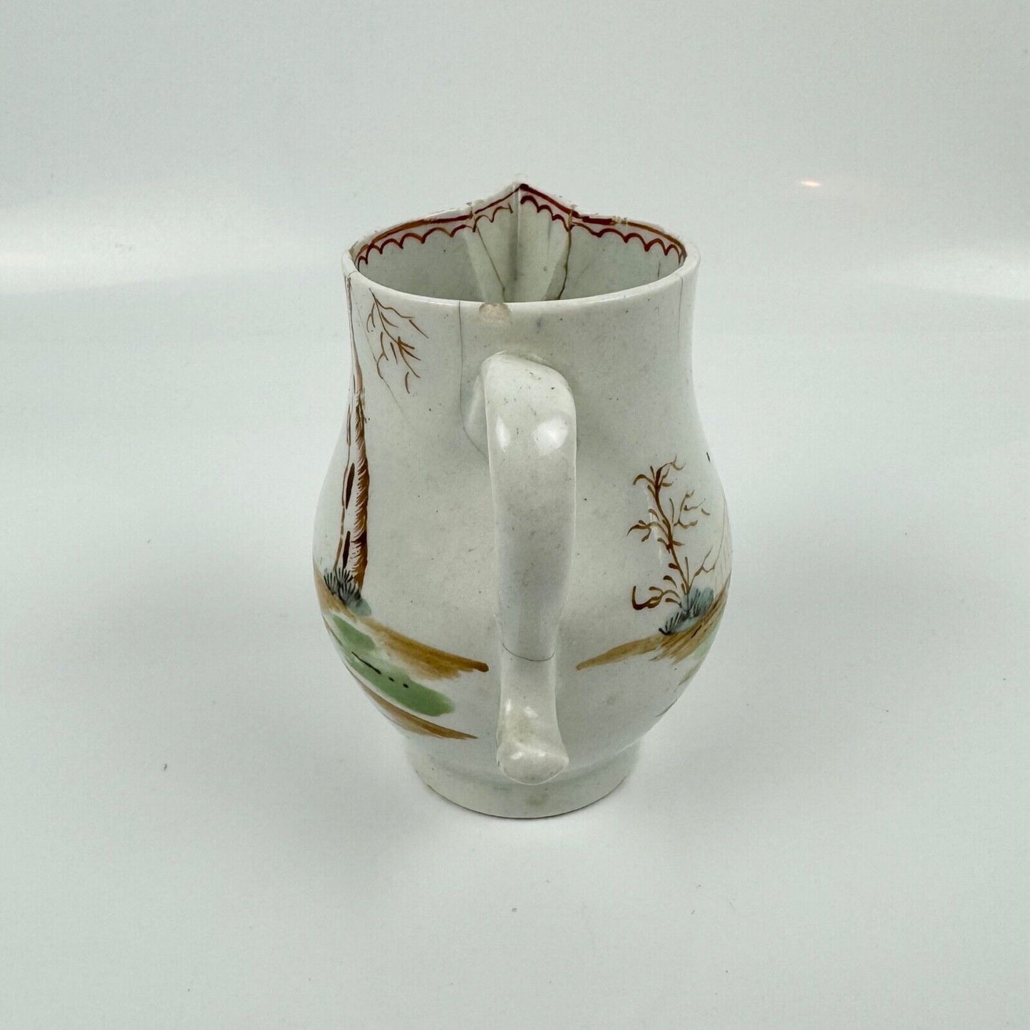 A Lowestoft sparrowbeak creamer c1775 painted with an Oriental figural pattern