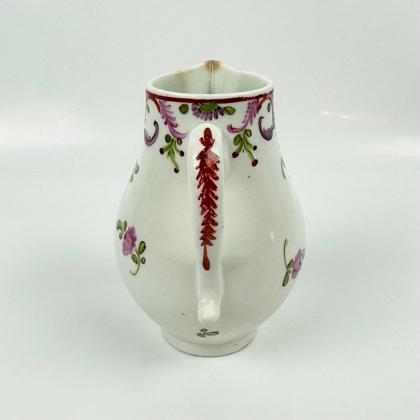 A Lowestoft sparrowbeak creamer c1775 painted with a Curtis style pattern