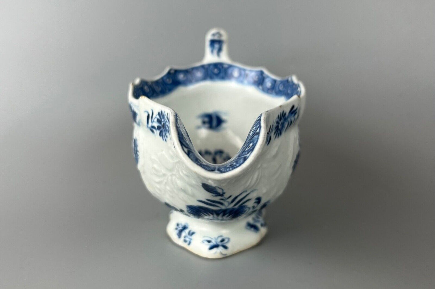 A mid 18thc Bow moulded sauceboat painted in underglaze blue c1765-70