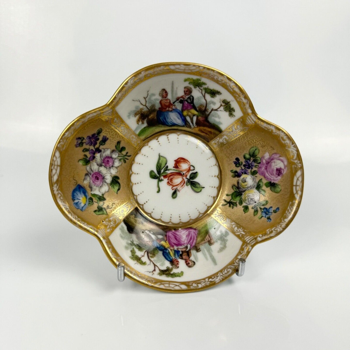 Dresden quatrefoil teacup & saucer painted with romantic scenes. 'AR' mark c1880