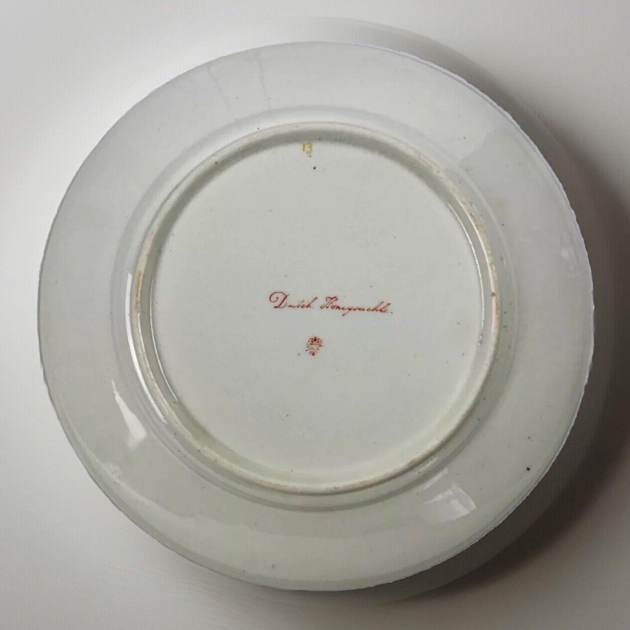 A Quaker Pegg Derby botanical plate with Dutch Honeysuckle study c.1813-15.