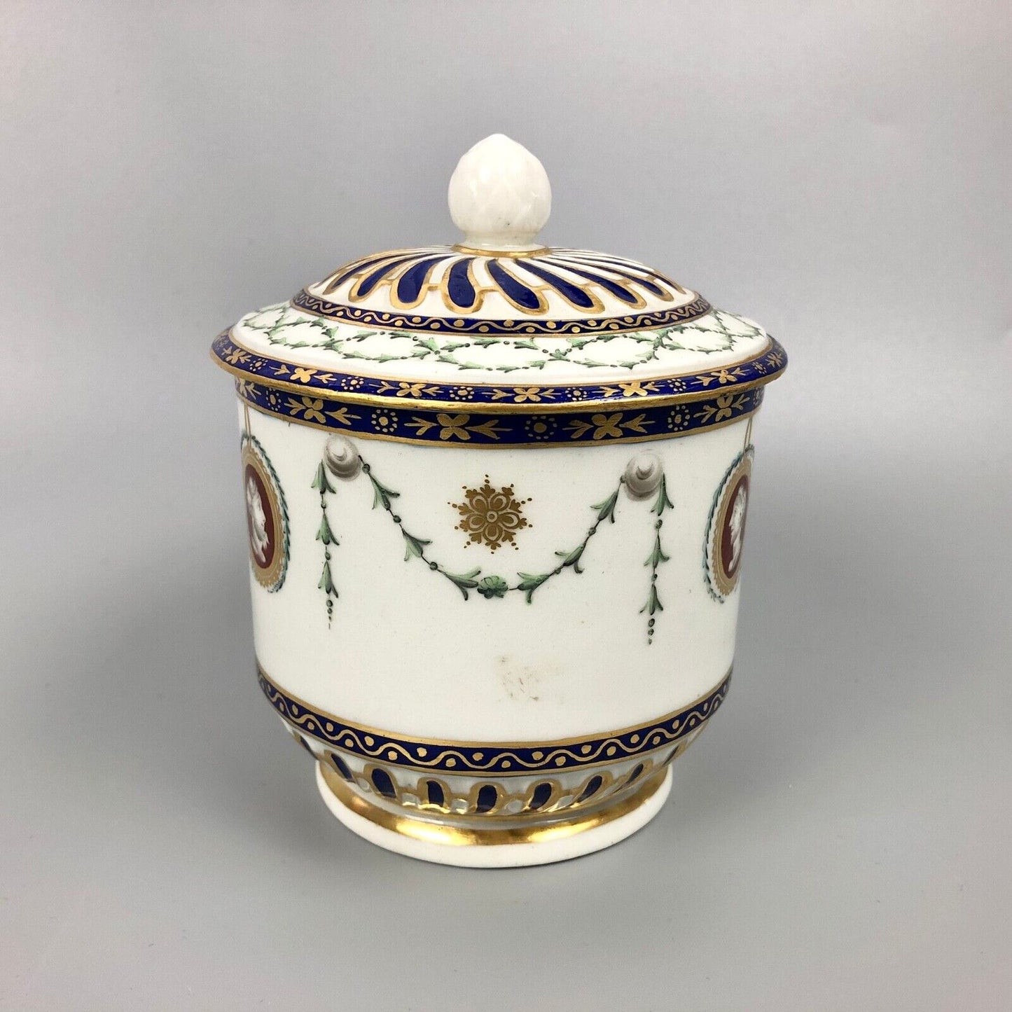 A rare Chelsea-Derby empire-shaped sucrier with classical masks. c.1770