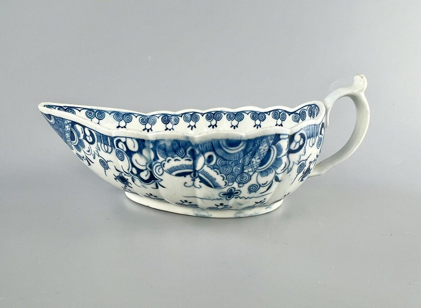 A Worcester First Period "Doughnut Tree" sauceboat. c.1777