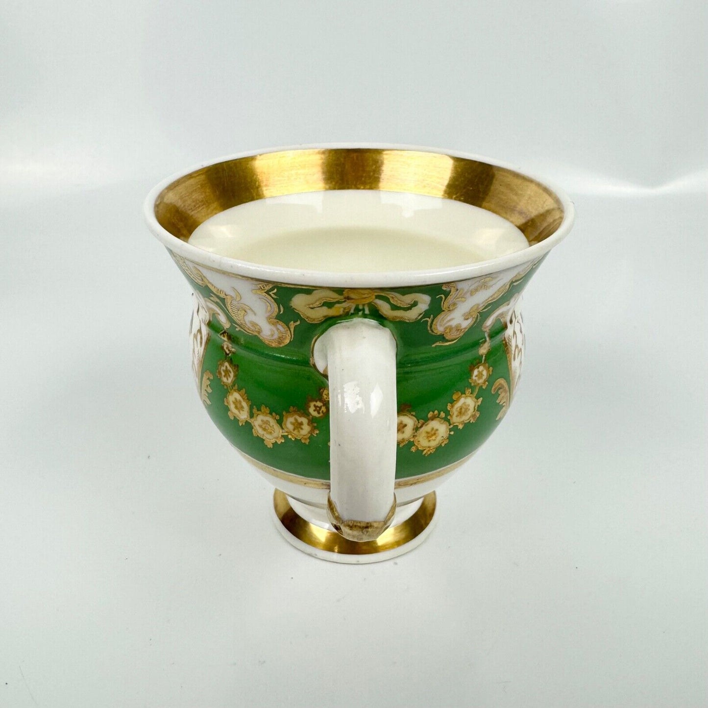 Rockingham horsetail & hoof handled coffee cup& saucer. Red griffin mark. c1826.