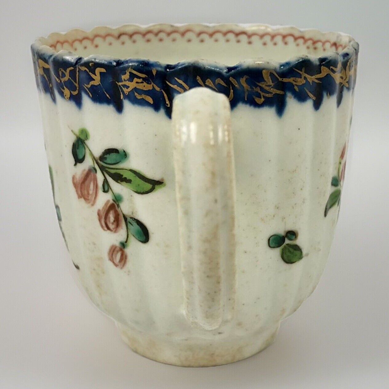 A Seth Pennington fluted coffee cup with blue and gilt border .1780-90