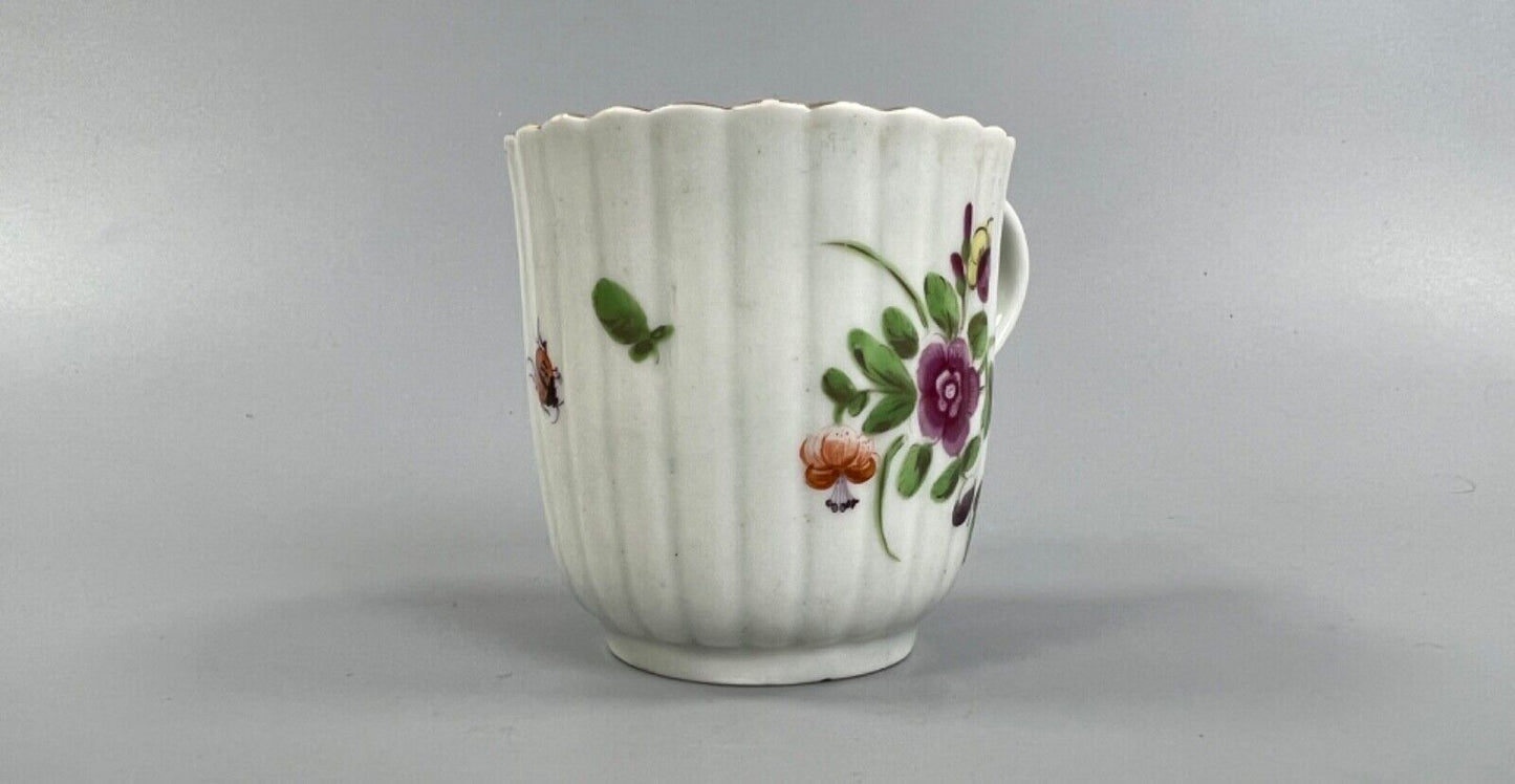 A Worcester reeded French shape coffee cup, painted with flowers and a ladybird