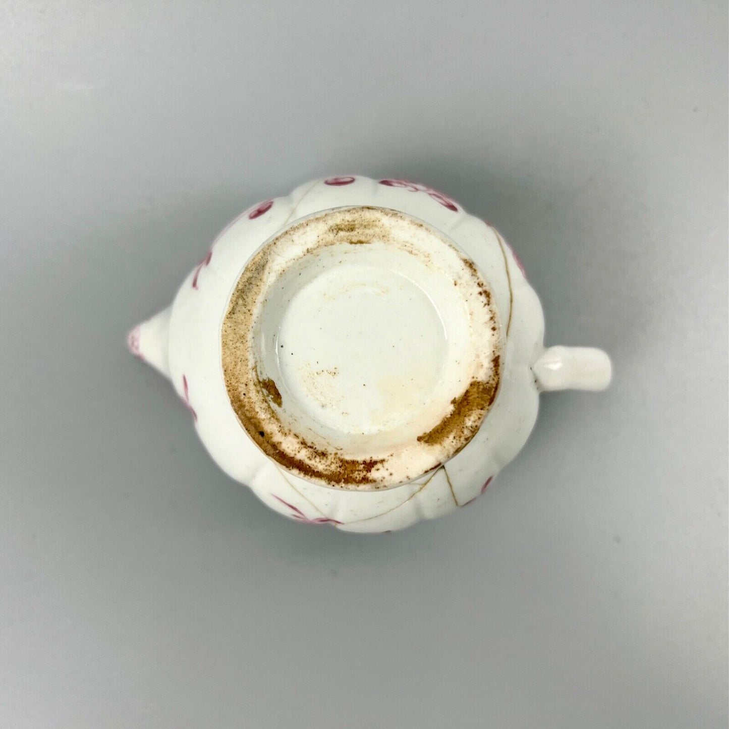 A rare early Derby peach-shaped creamer in 'Banded Hedge' pattern c.1765