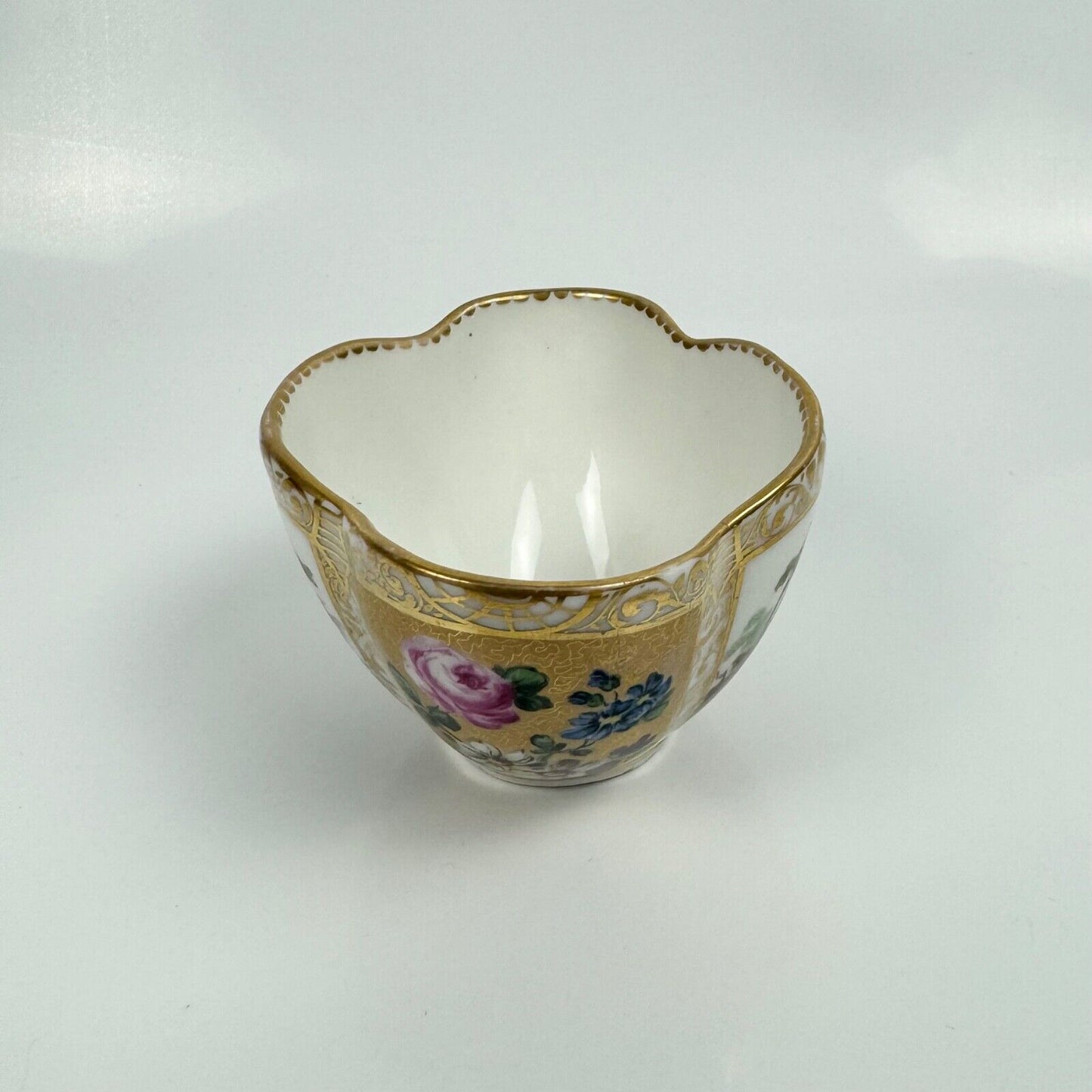 Dresden quatrefoil teacup & saucer painted with romantic scenes. 'AR' mark c1880