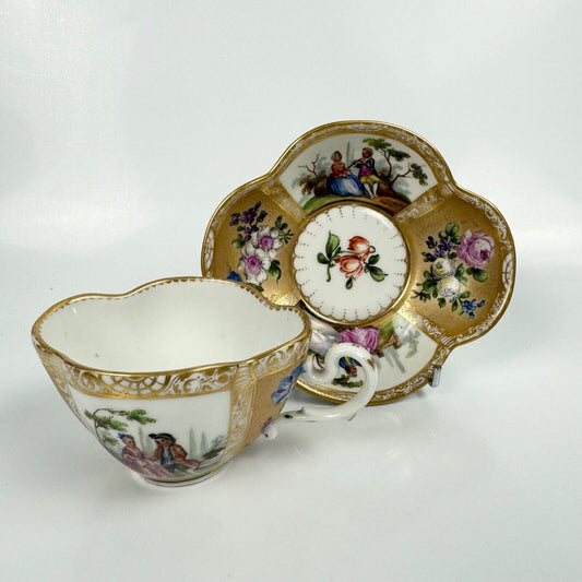 Dresden quatrefoil teacup & saucer painted with romantic scenes. 'AR' mark c1880