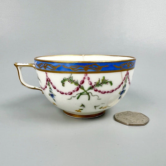 A Sèvres teacup painted by Mde Nouallhier. Date mark mm for 1789. Incised mark
