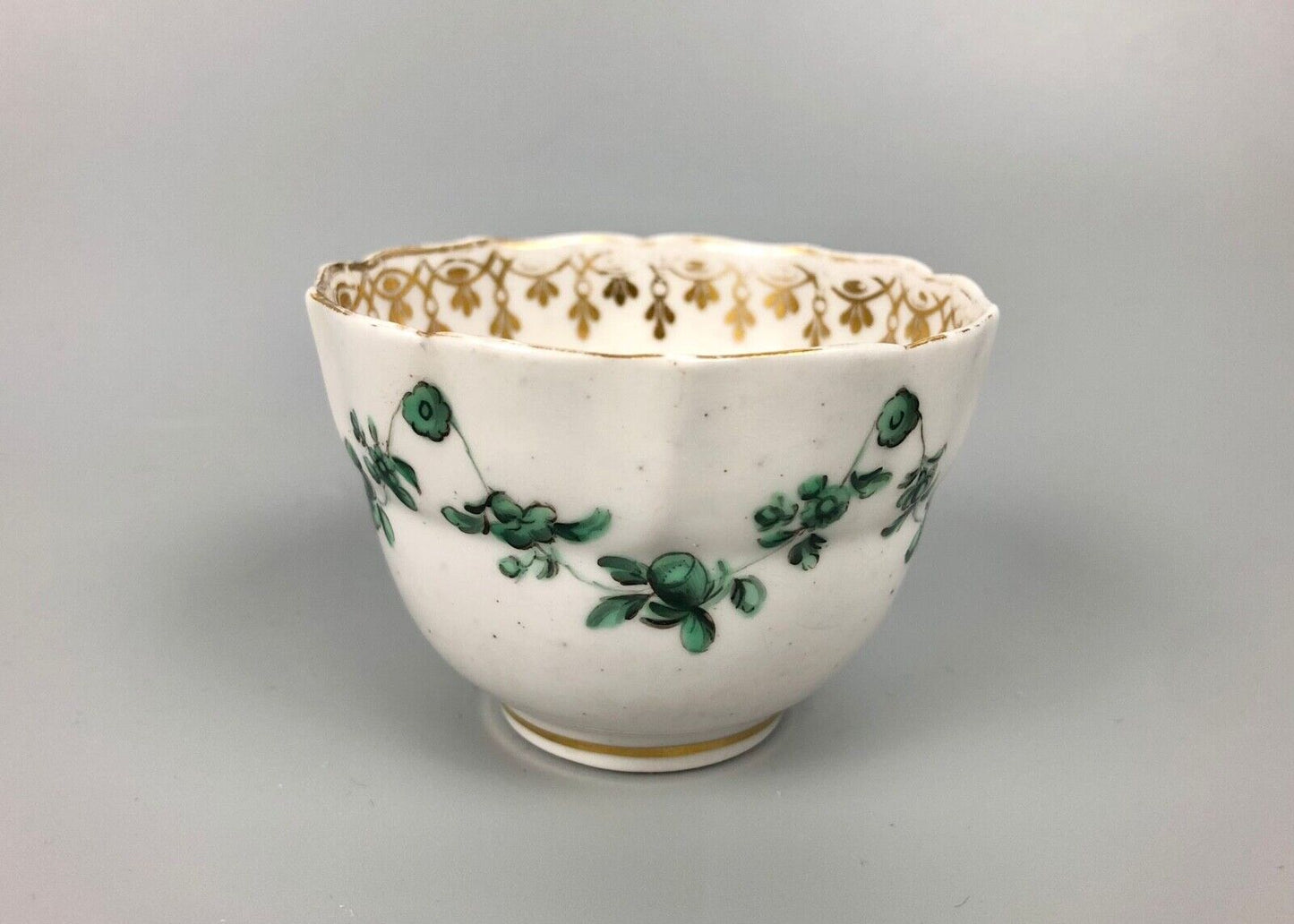 A Derby tea bowl and saucer in the style of Bristol c.1775