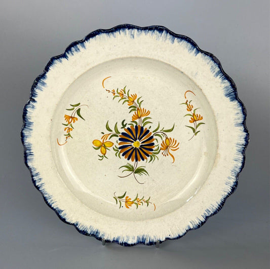 A c.1790-1810 shell moulded pearlware plate with painted floral decoration.#1