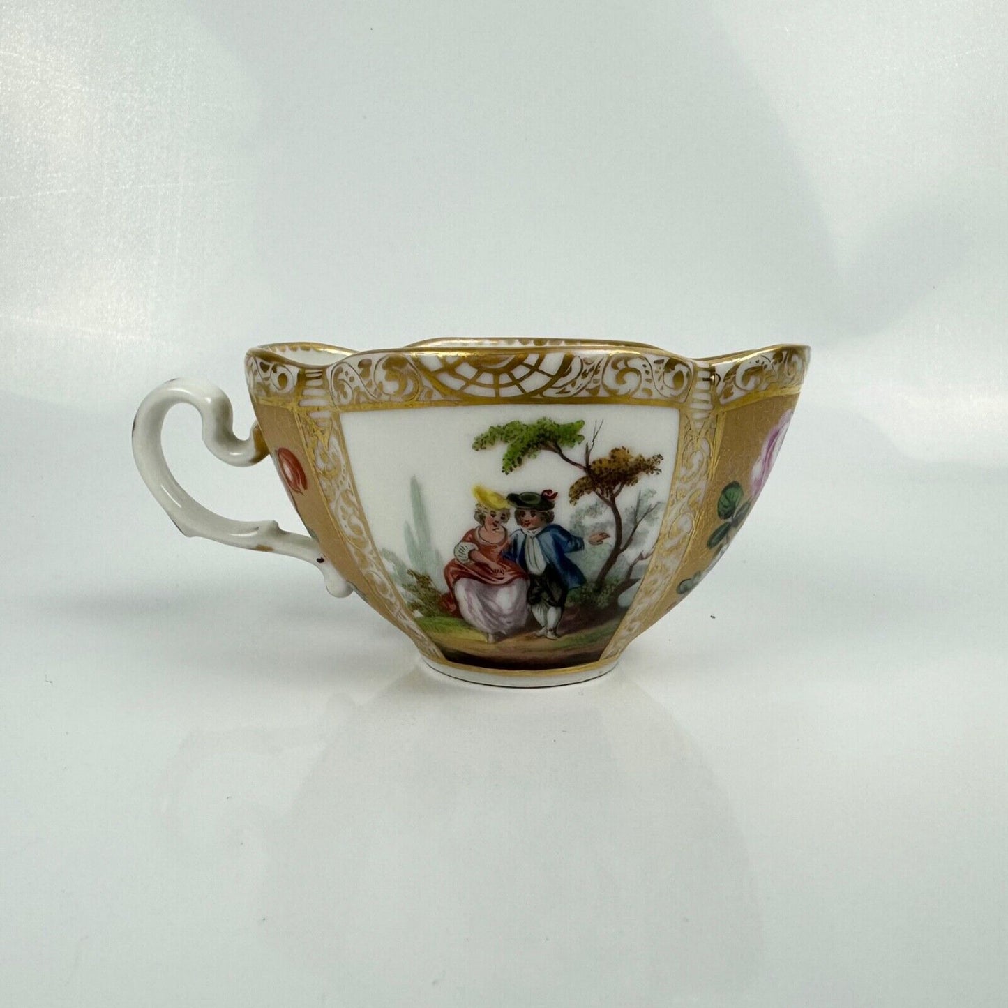 Dresden quatrefoil teacup & saucer painted with romantic scenes. 'AR' mark c1880