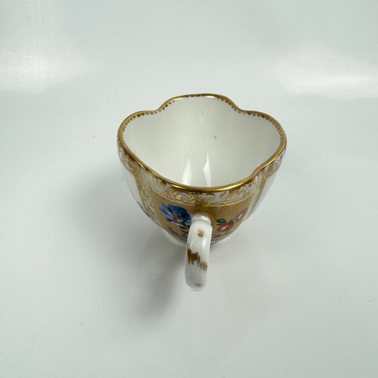 Dresden quatrefoil teacup & saucer painted with romantic scenes. 'AR' mark c1880