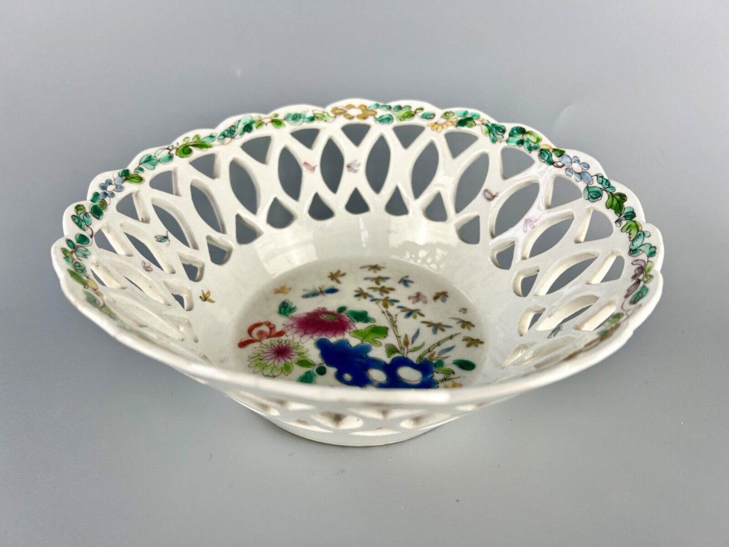 A fine and early Bow porcelain famille rose reticulated basket c.1752
