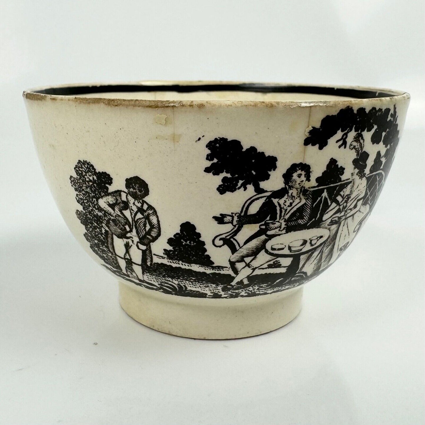 A "tea party" creamware tea bowl and saucer. c.1790.  Probably Staffordshire