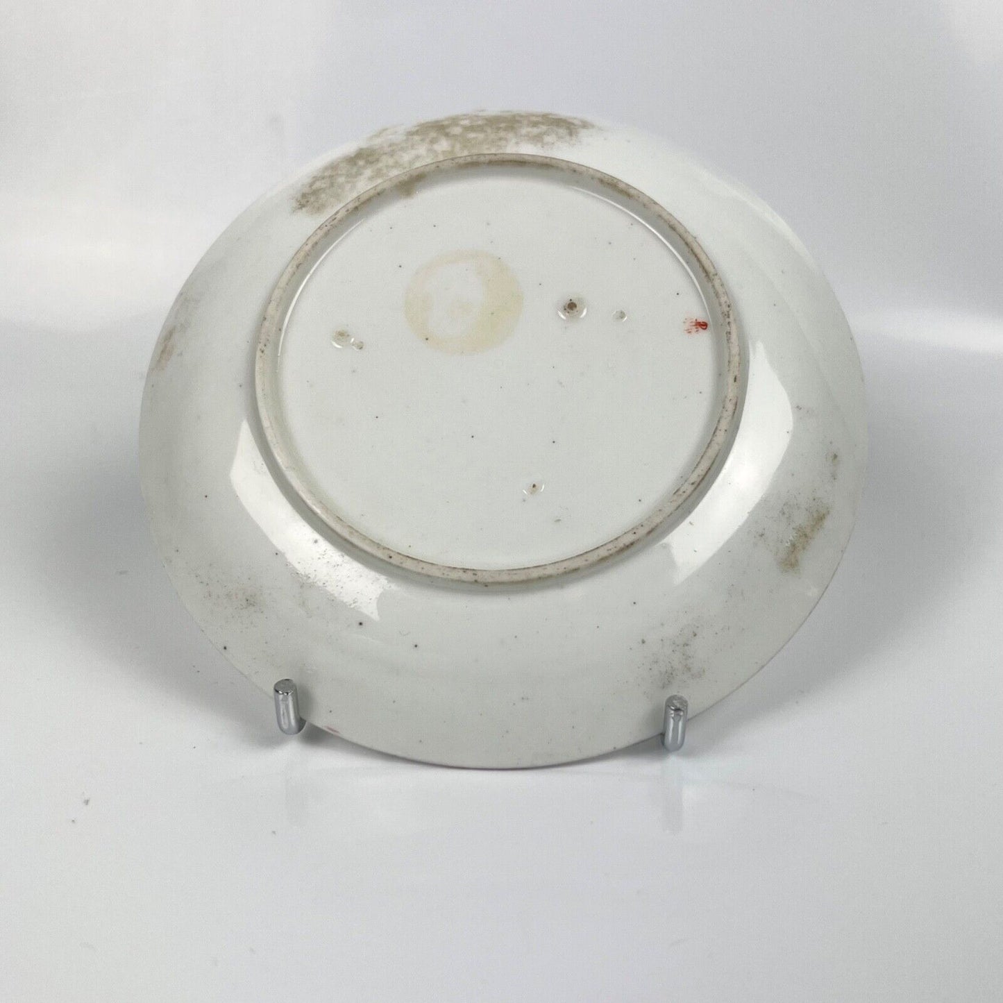A A Chelsea floral-painted saucer with brown rim. c.1758