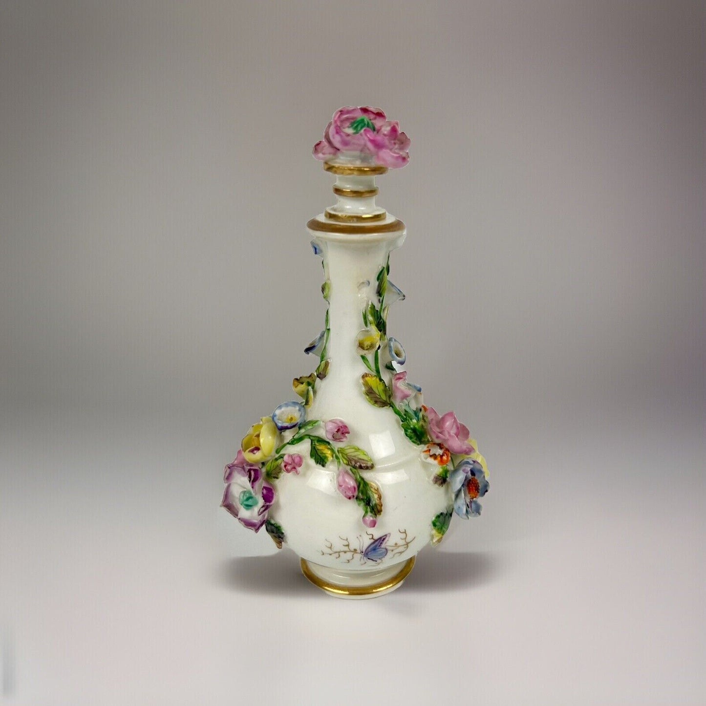 Rockingham porcelain flower encrusted tapered scent bottle. Puce Mark. c.1831-7