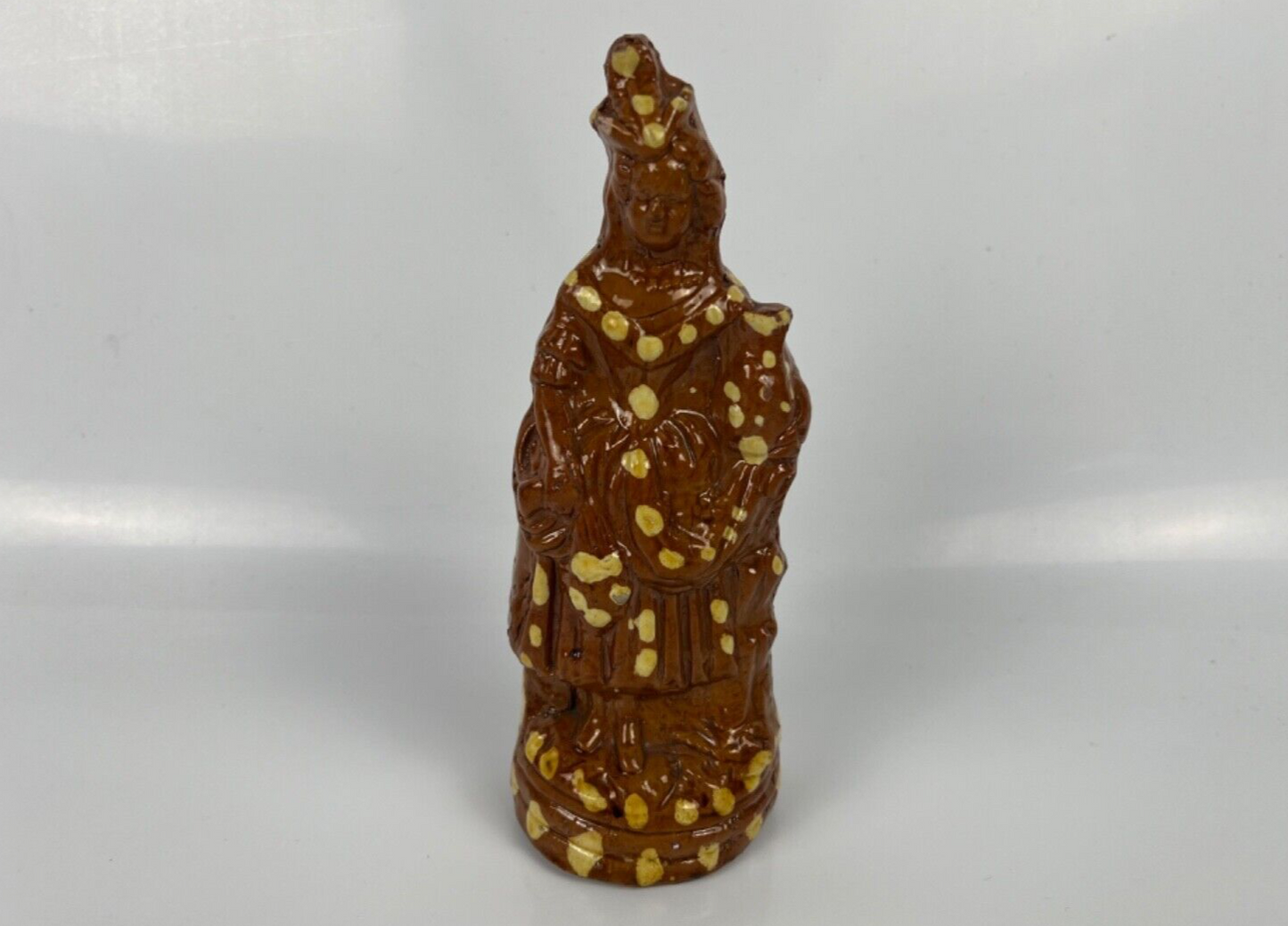A cream dot decorated slipware figure of a woman on a treacle ground c1835