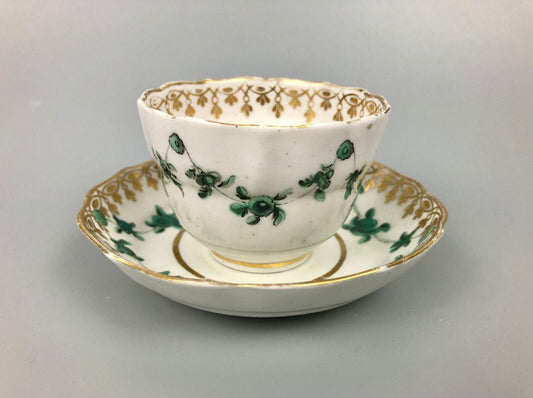 A Derby tea bowl and saucer in the style of Bristol c.1775