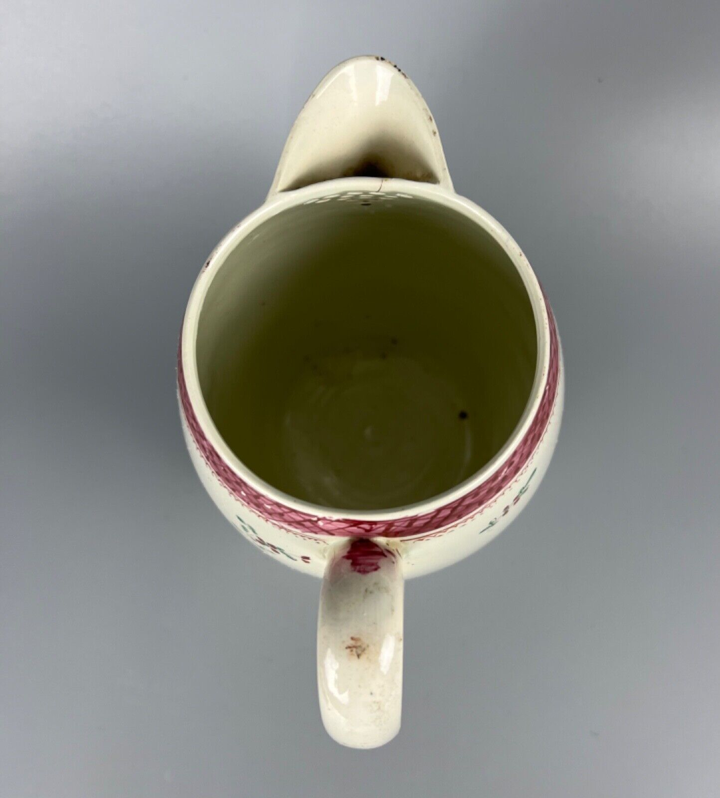A late 18thc pearlware covered jug. Polychrome floral decoration.