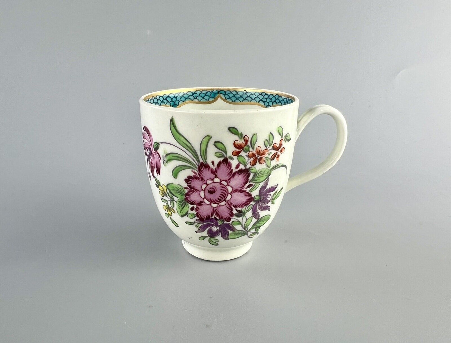 A 1st Period Worcester polychrome coffee cup c1770. Sprung handle.