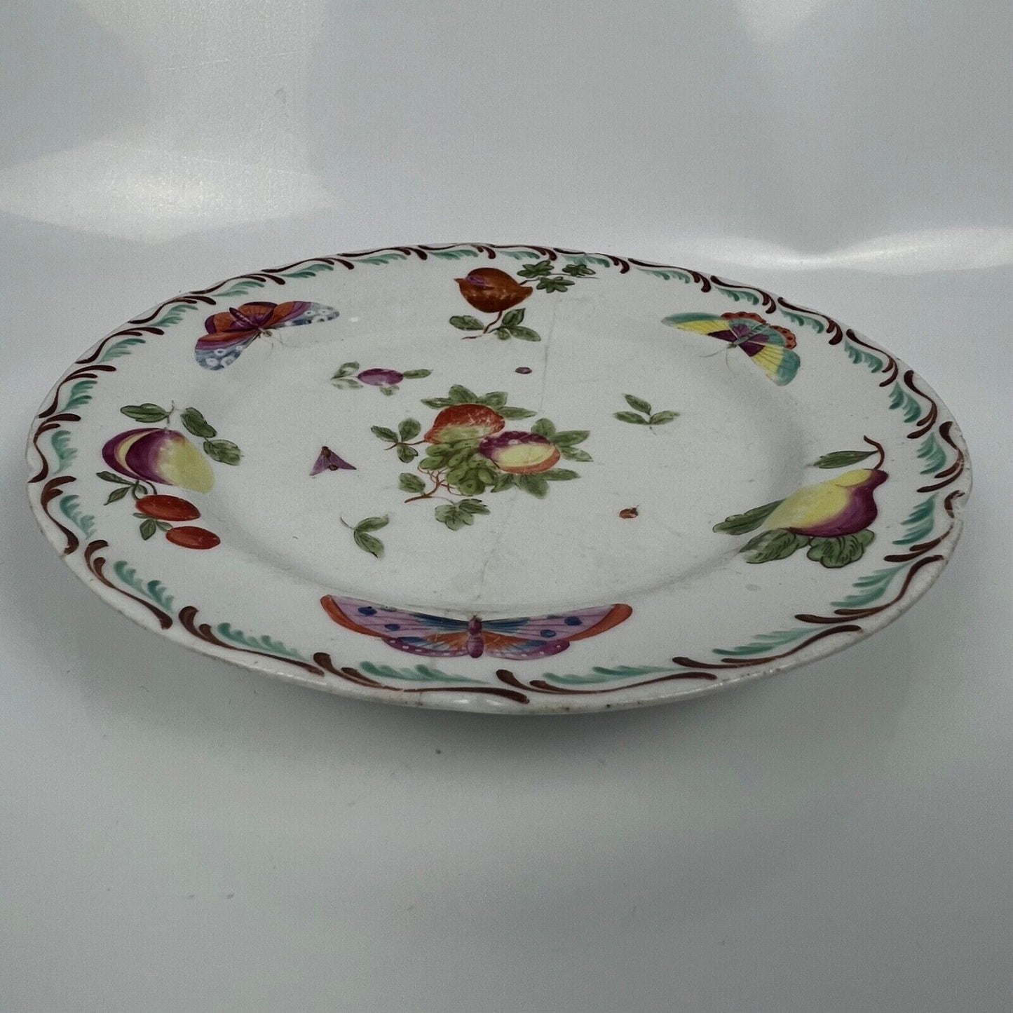 A Derby feather-moulded plate painted with fruit and insects c.1770