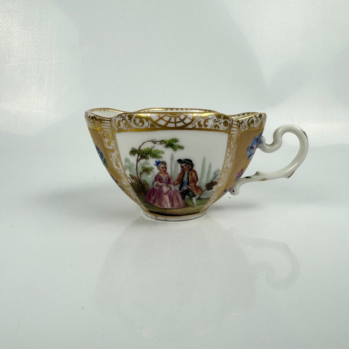 Dresden quatrefoil teacup & saucer painted with romantic scenes. 'AR' mark c1880