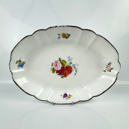 Nantgarw locally decorated lozenge-shaped dish. Impressed "CW" Mark 1810–15