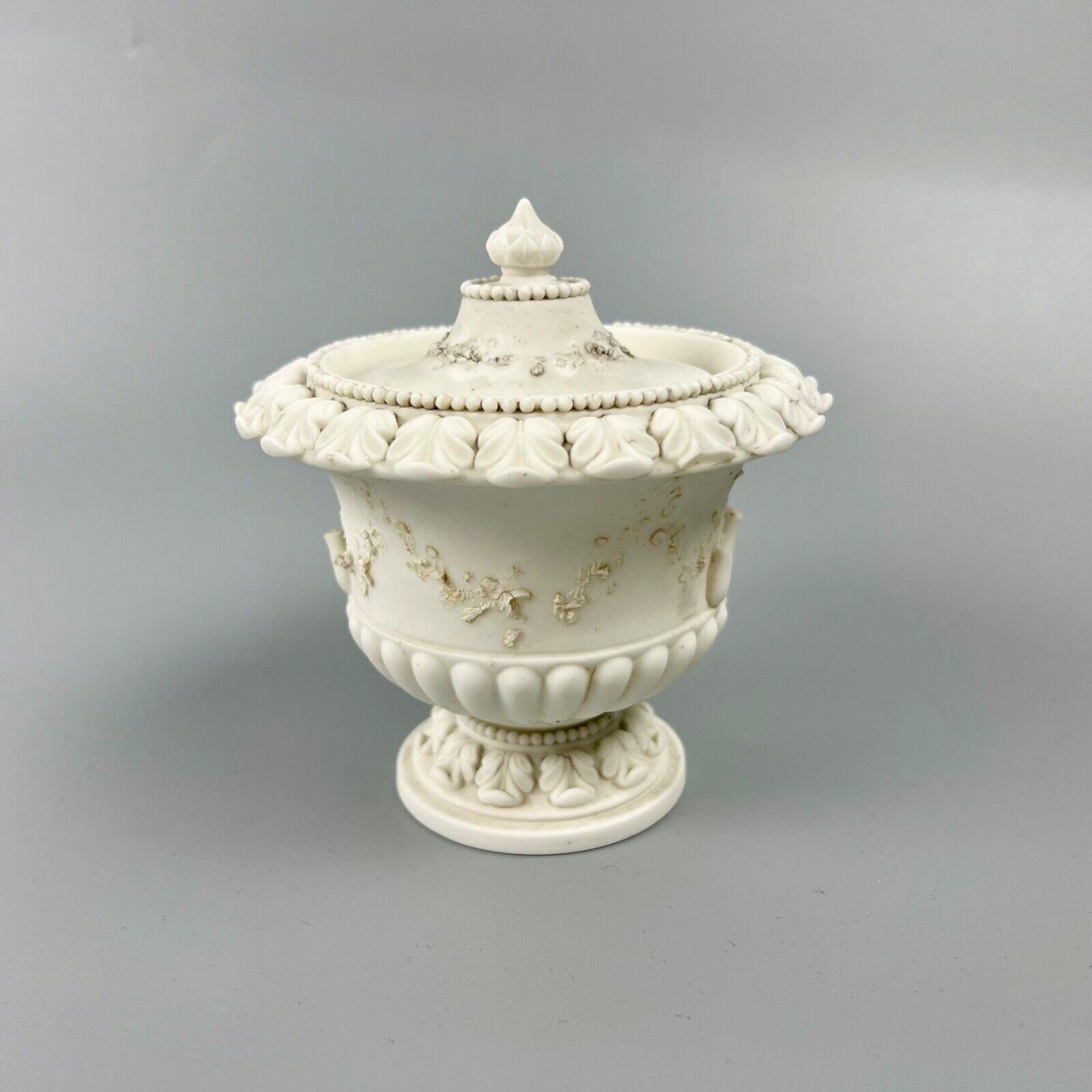 A  rare Swansea biscuit lidded urn modelled with flowers and acanthus. c1814-17