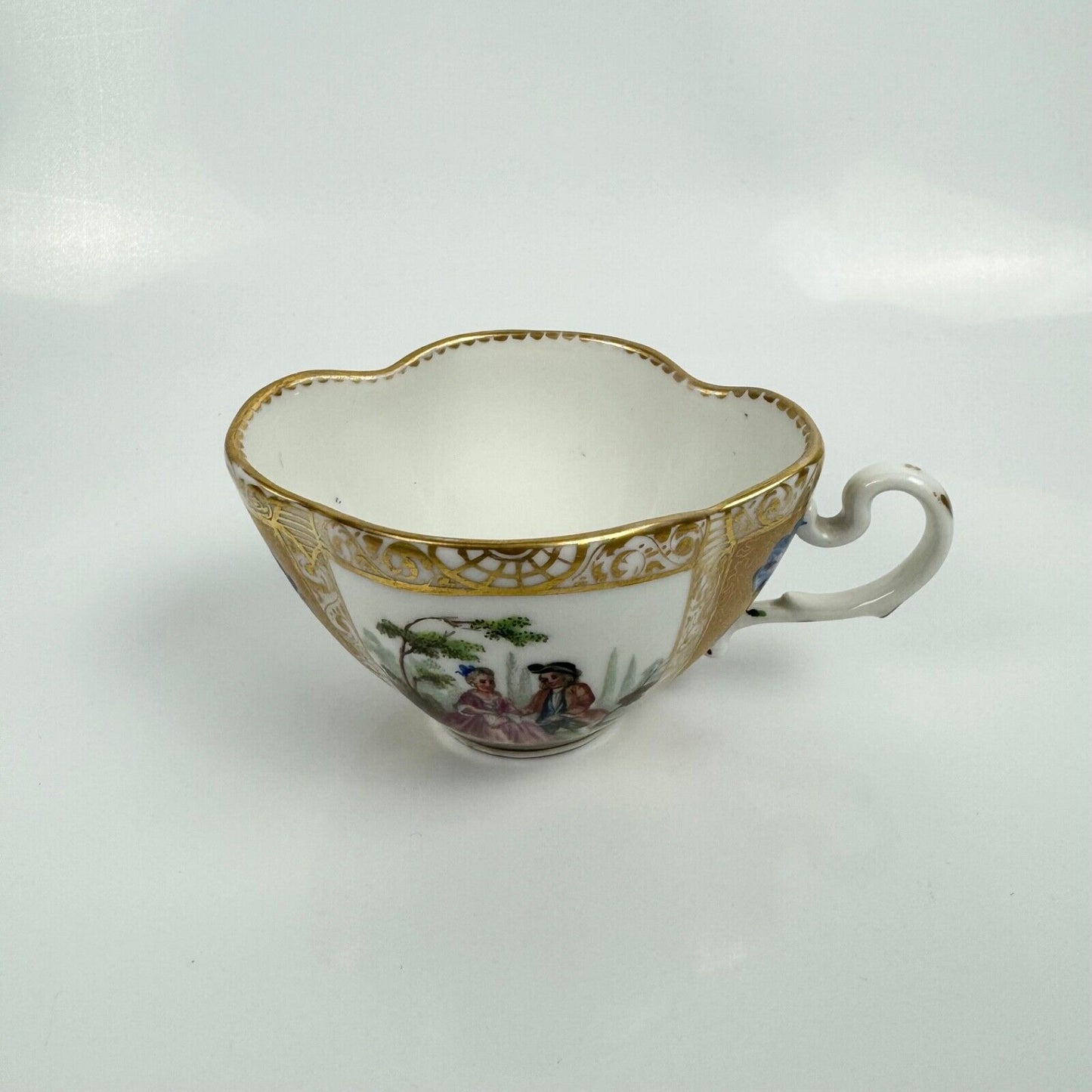 Dresden quatrefoil teacup & saucer painted with romantic scenes. 'AR' mark c1880