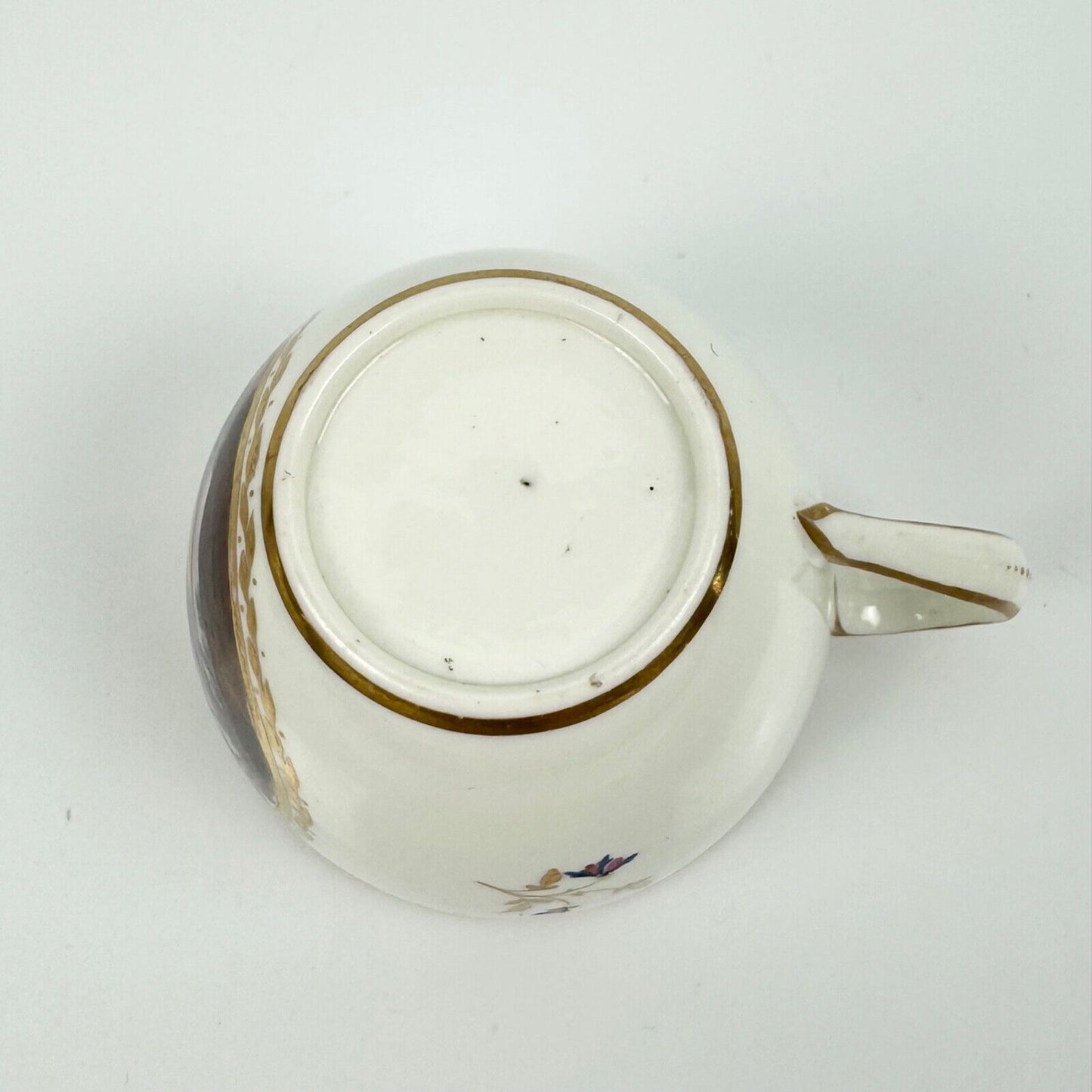 A Pinxton cup and saucer in pattern 174 with painted scenes by Billingsley c1810