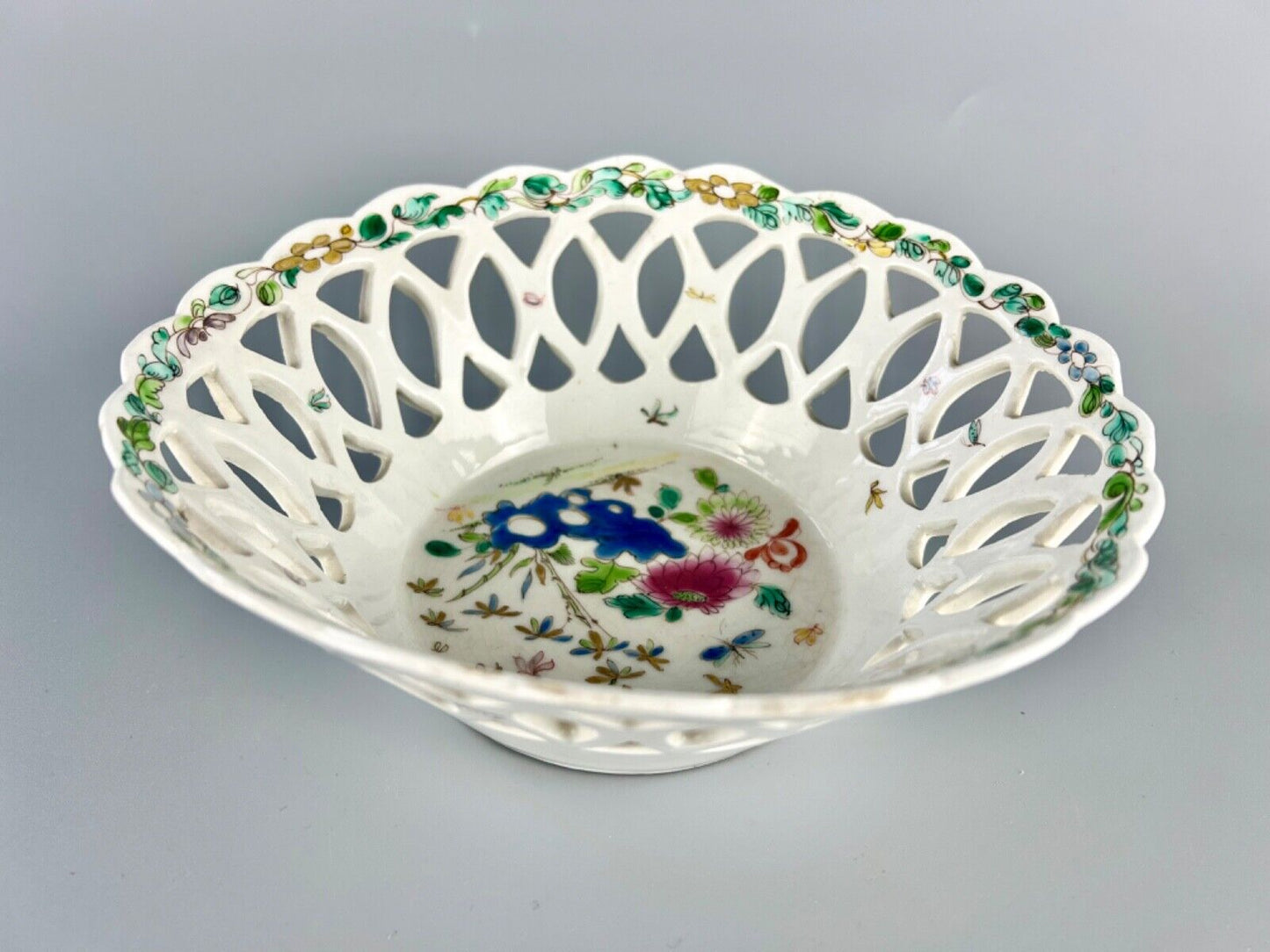 A fine and early Bow porcelain famille rose reticulated basket c.1752