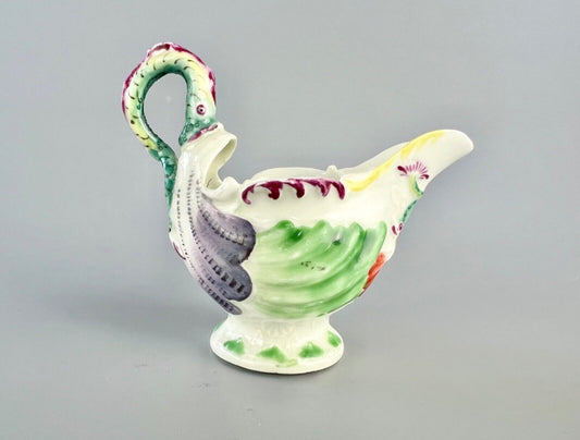 A c.1765 Worcester lamprey-handled dolphin-ewer creamer. Polychrome decoration.