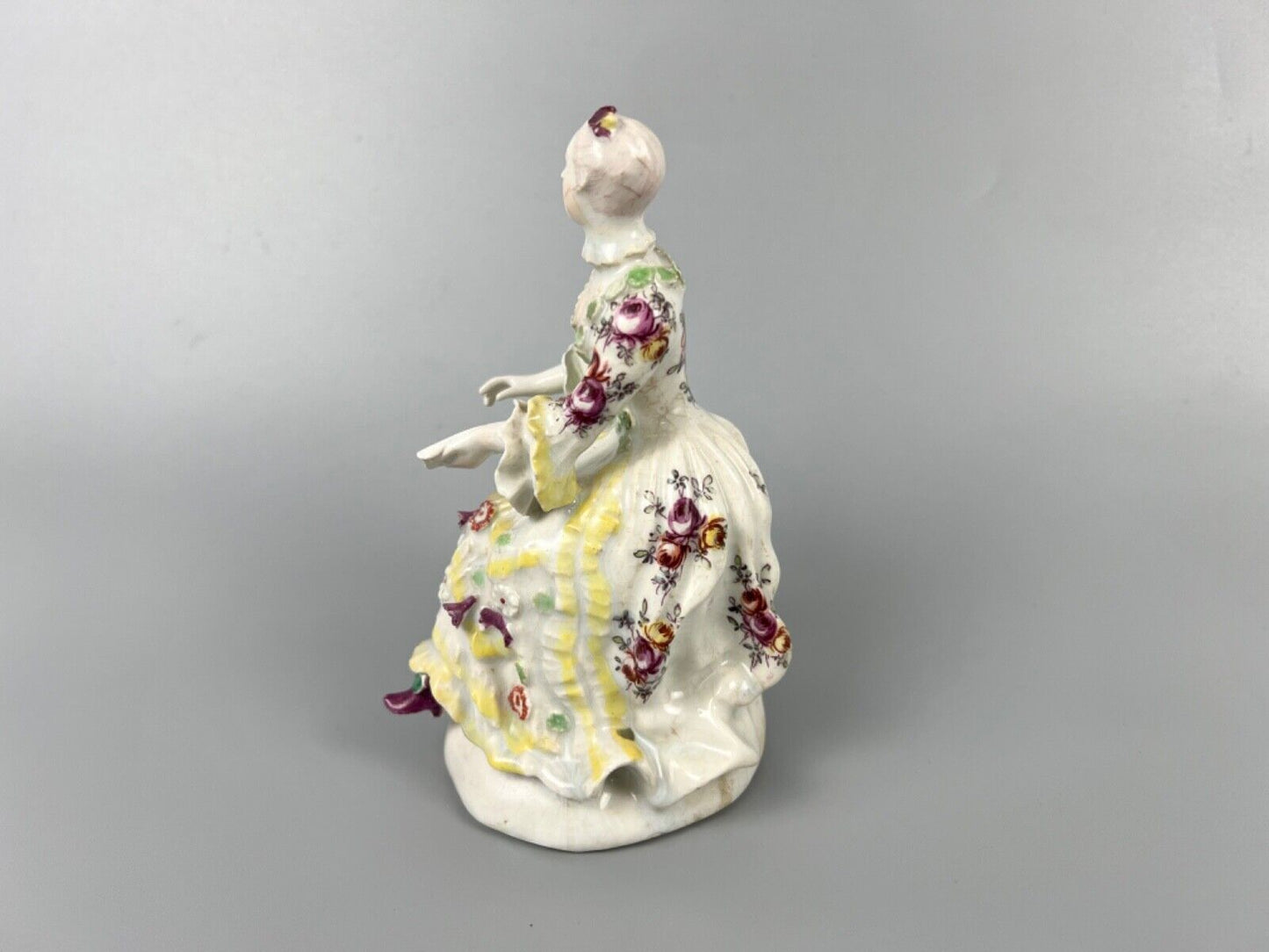 A Derby 'Pale Family' figure of 'Lady Seated Holding a Musical Score'. c1756-9