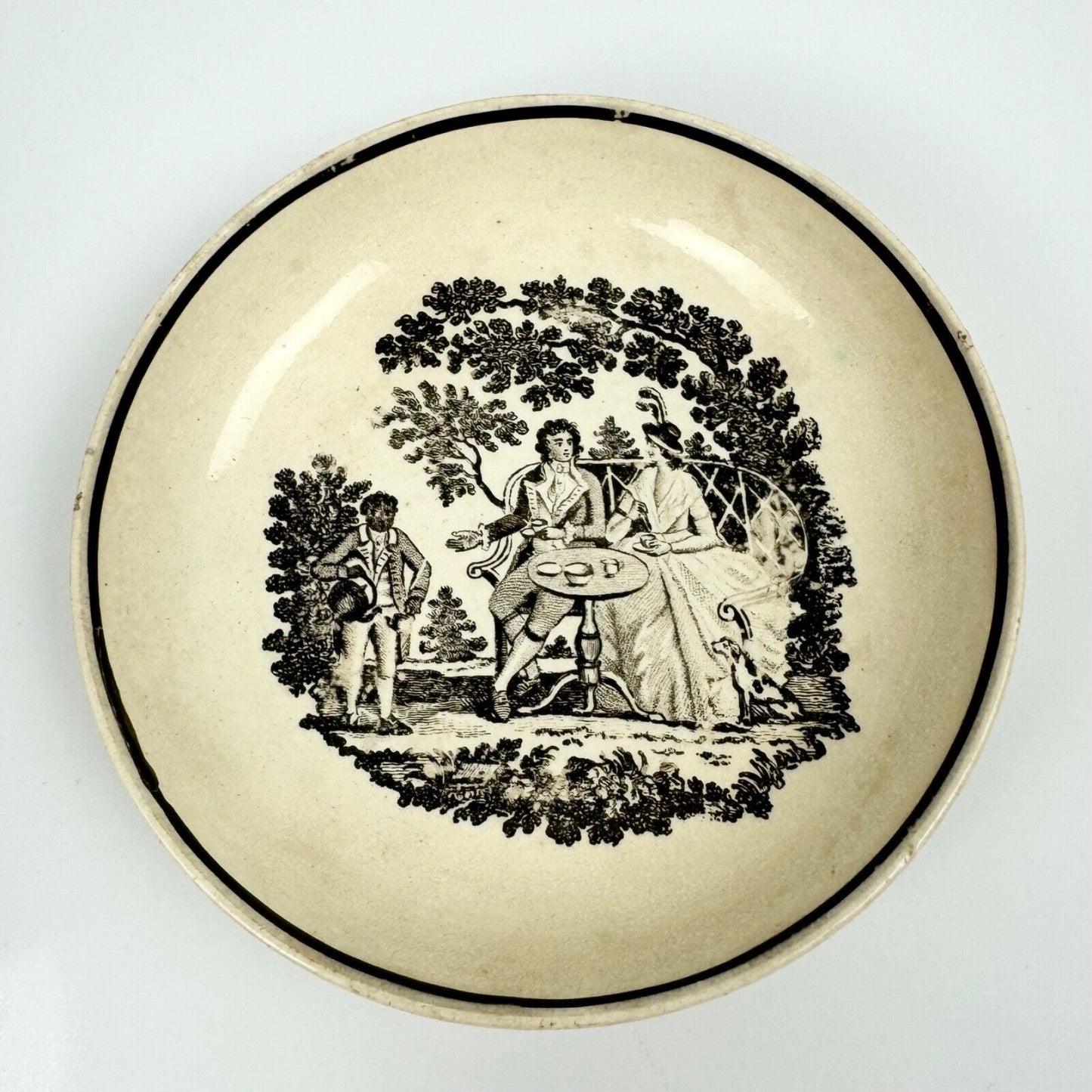 A "tea party" creamware tea bowl and saucer. c.1790.  Probably Staffordshire