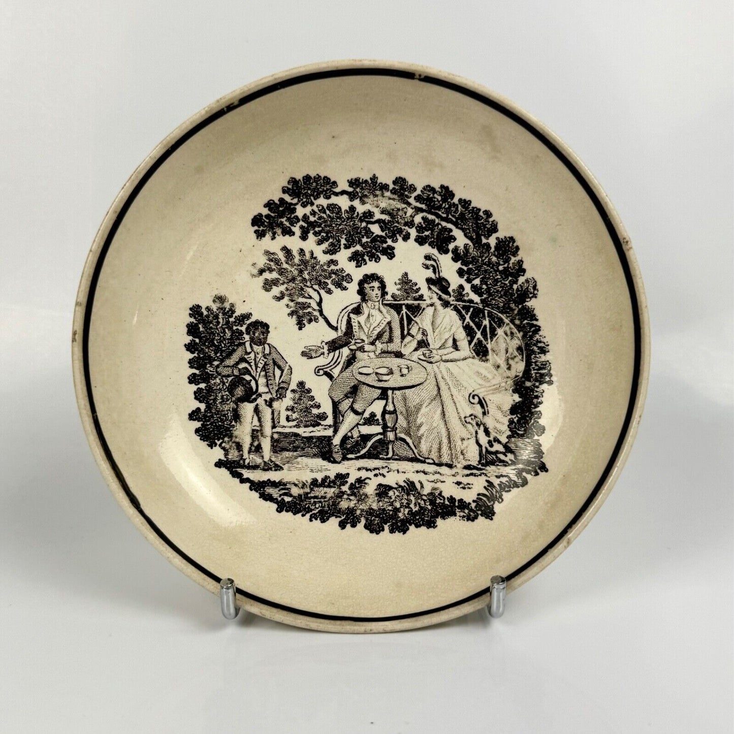A "tea party" creamware tea bowl and saucer. c.1790.  Probably Staffordshire