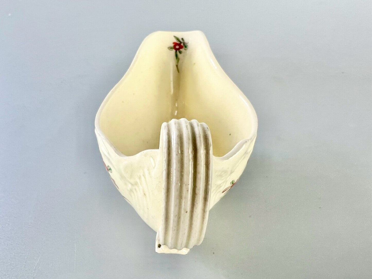 A c1775 creamware sauceboat painted with floral sprays. Probably Staffordshire.